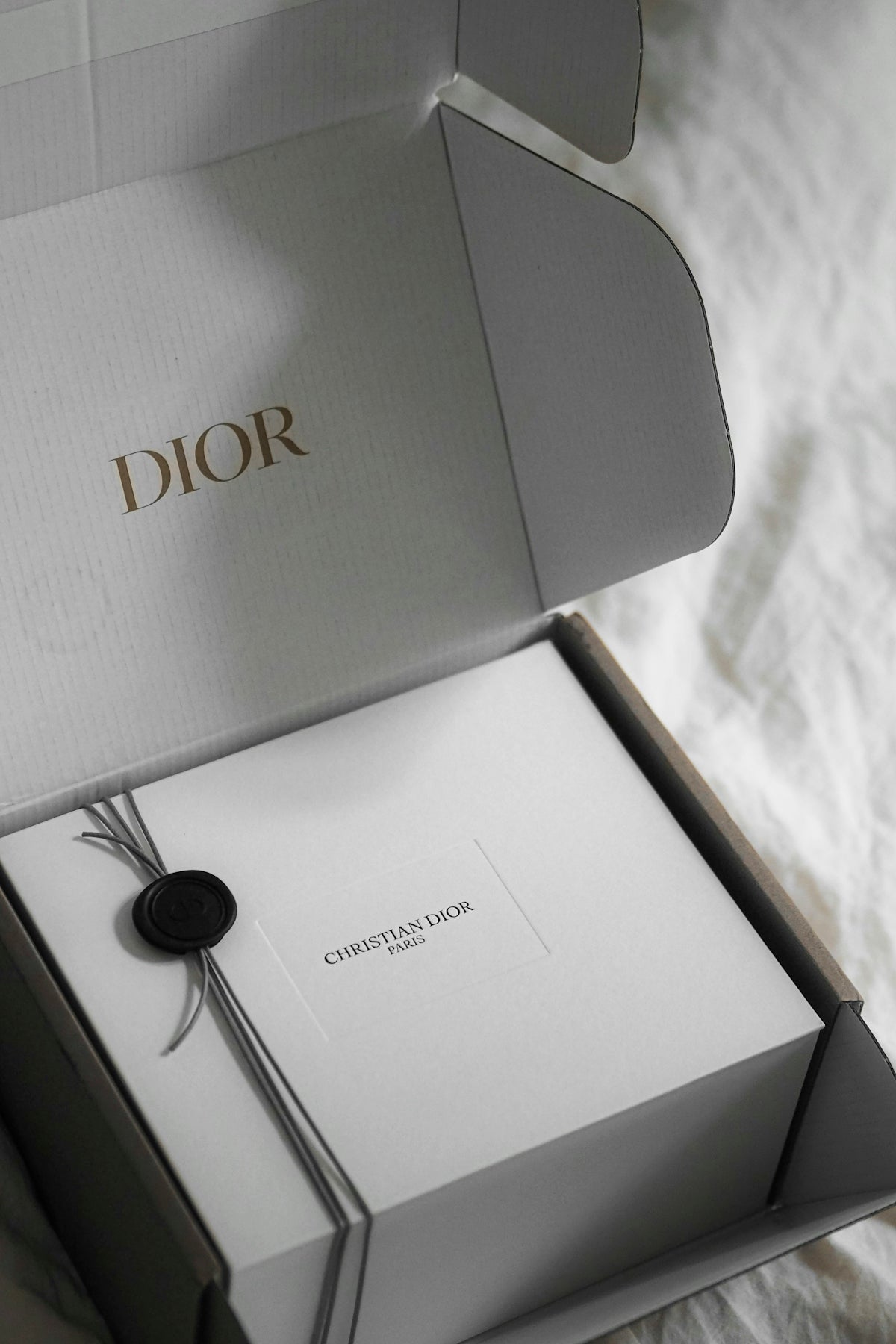 Dior gift box with wax seal and ribbon