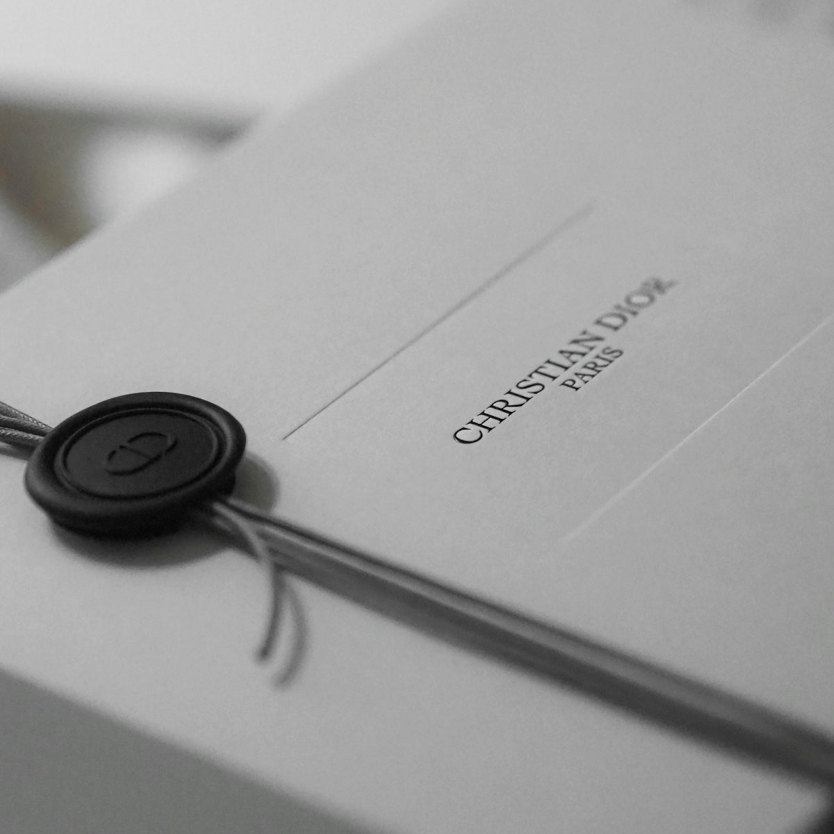 White dior gift box with black wax seal