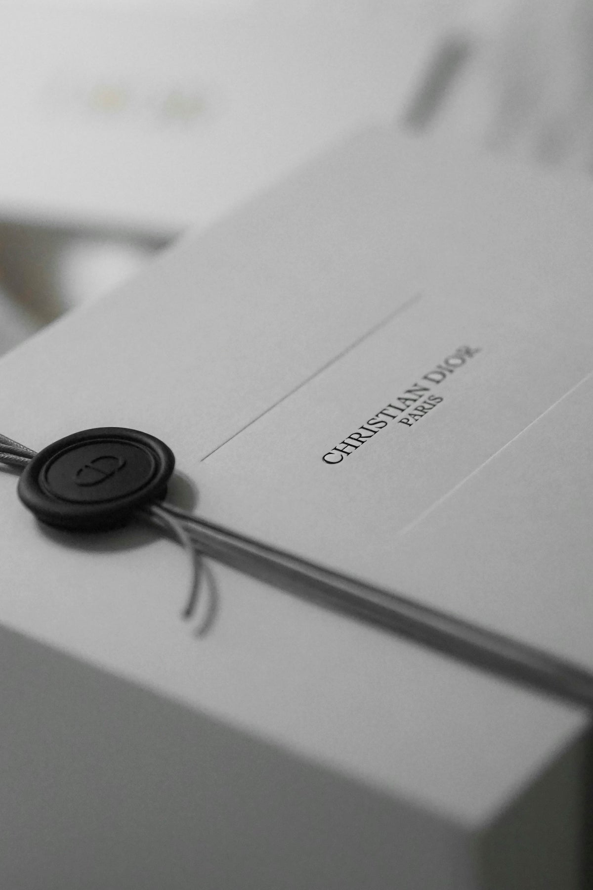 White dior gift box with black wax seal