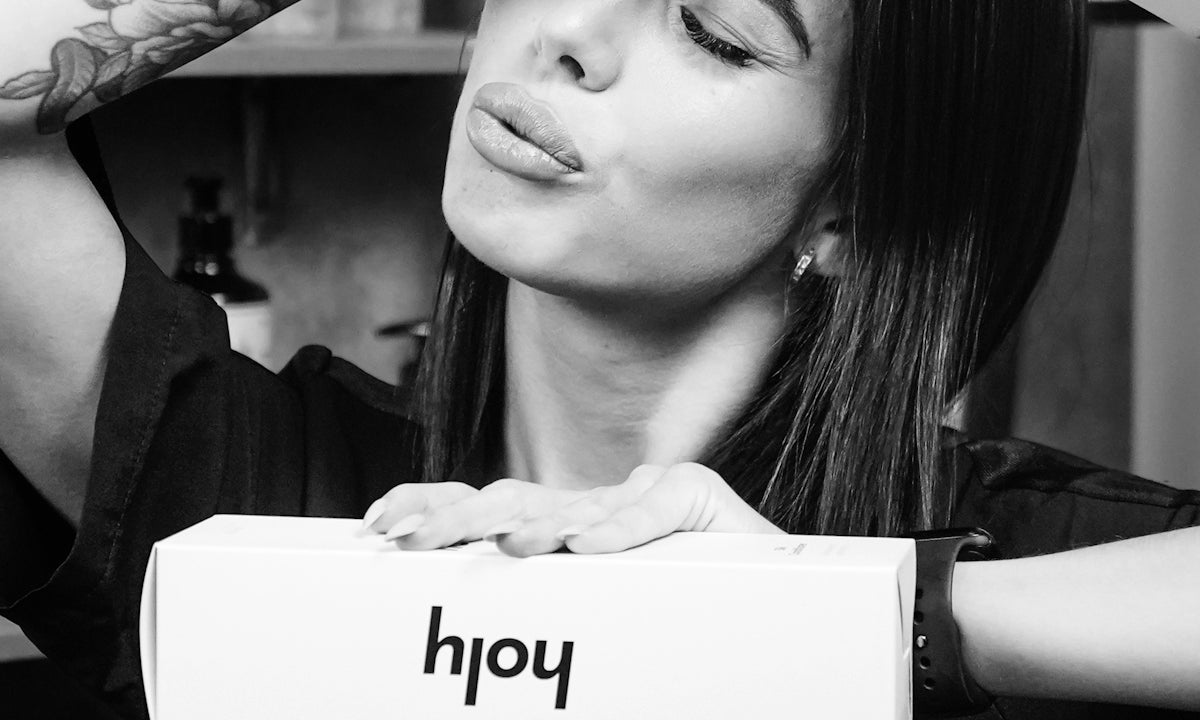 Woman holding boxes with her head and hands